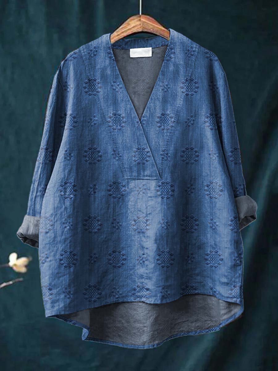 Blue linen blouse with V-neck and all-over floral embroidery, relaxed drape