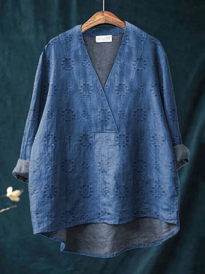 Blue linen blouse with V-neck and all-over floral embroidery, relaxed drape