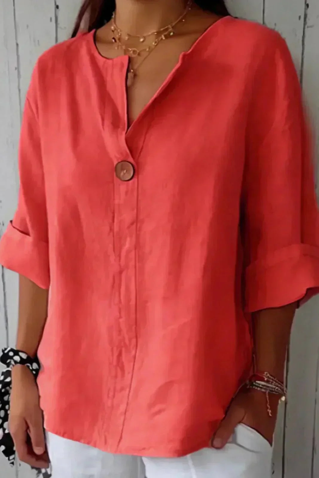 Red minimal button blouse with V-neck, short loose sleeves, and round front button