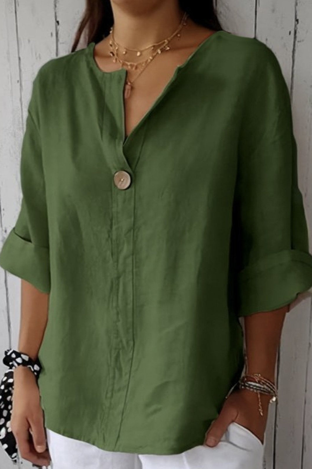 Green minimal button blouse with V-neck, short sleeves, and round front button