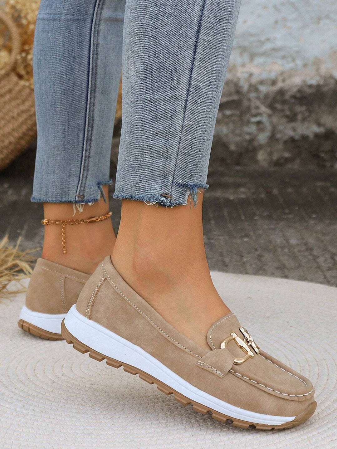 Khaki chain-detail slip-on loafers with gold hardware, stitched trim, white sole.