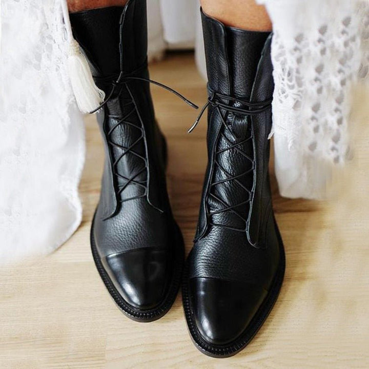 Black lace-up ankle boots with cushioned upper, rounded toe, and stitched rubber sole.