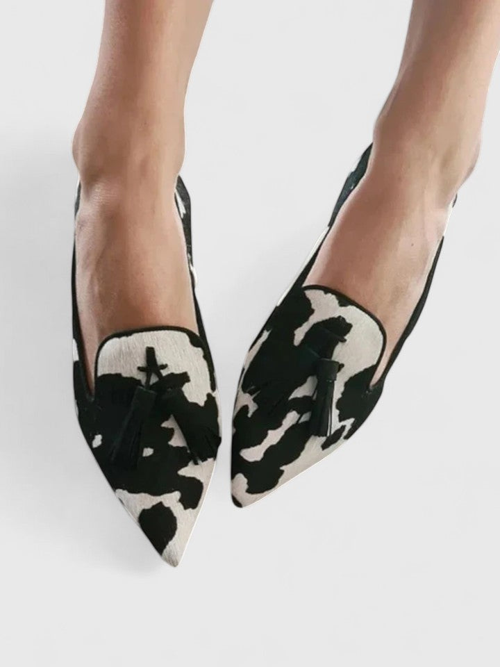 Slip-on flats with black-and-white cow-print pointed toe upper