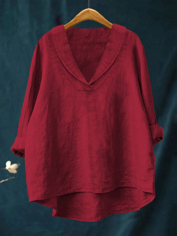 Red relaxed linen blouse with V-neck and loose fit, long sleeves, draped hem.