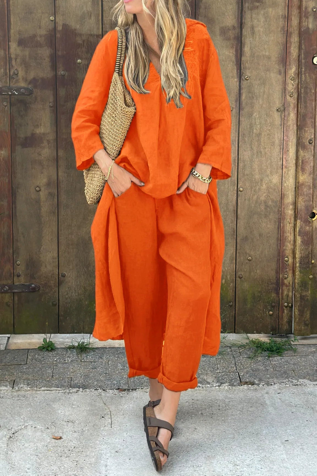 Orange two-piece lounge set with V-neck tunic top and cropped wide-leg pants