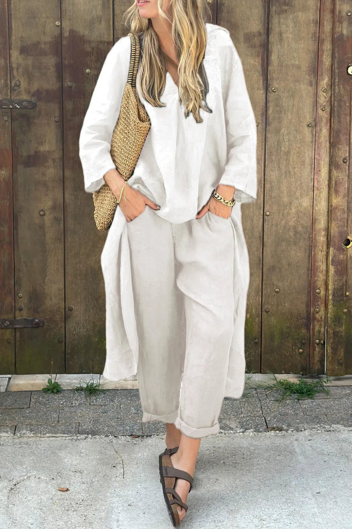 White two-piece lounge set with V-neck tunic top and cropped wide-leg pants