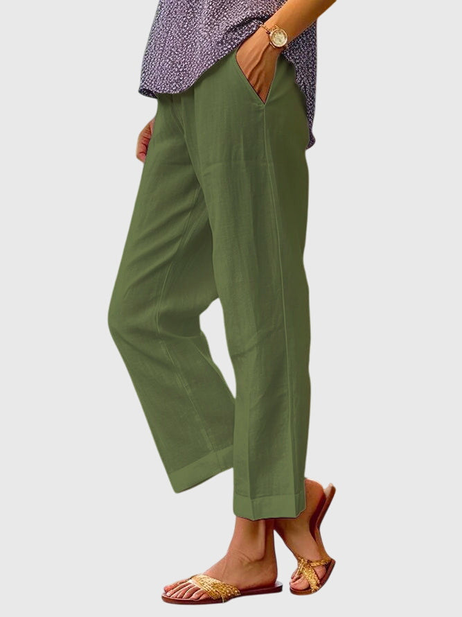 Green relaxed pants with side pockets and loose straight legs with ankle-length cuffed hem
