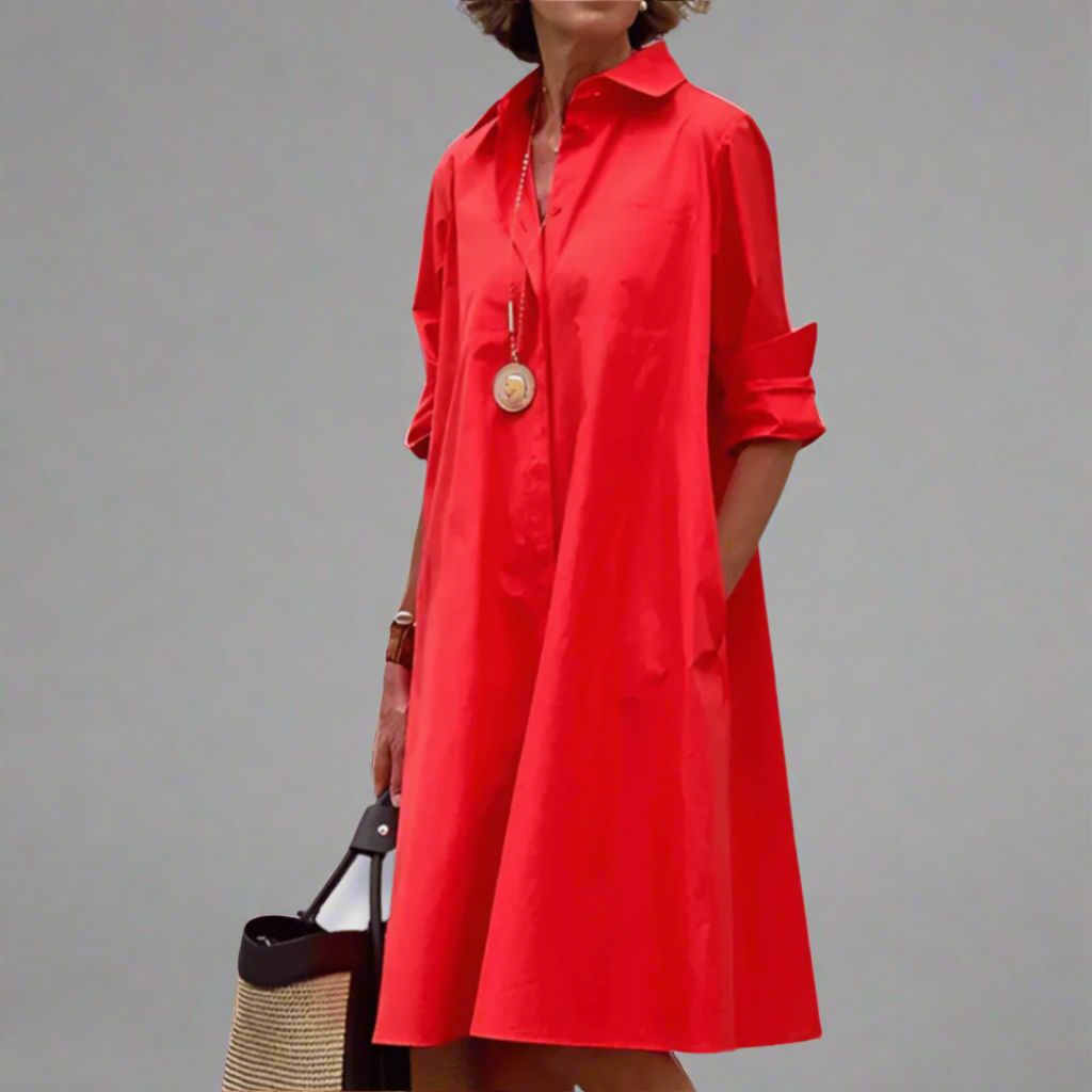 Red polo dress with pointed collar, button placket, three-quarter sleeves, gathered skirt.