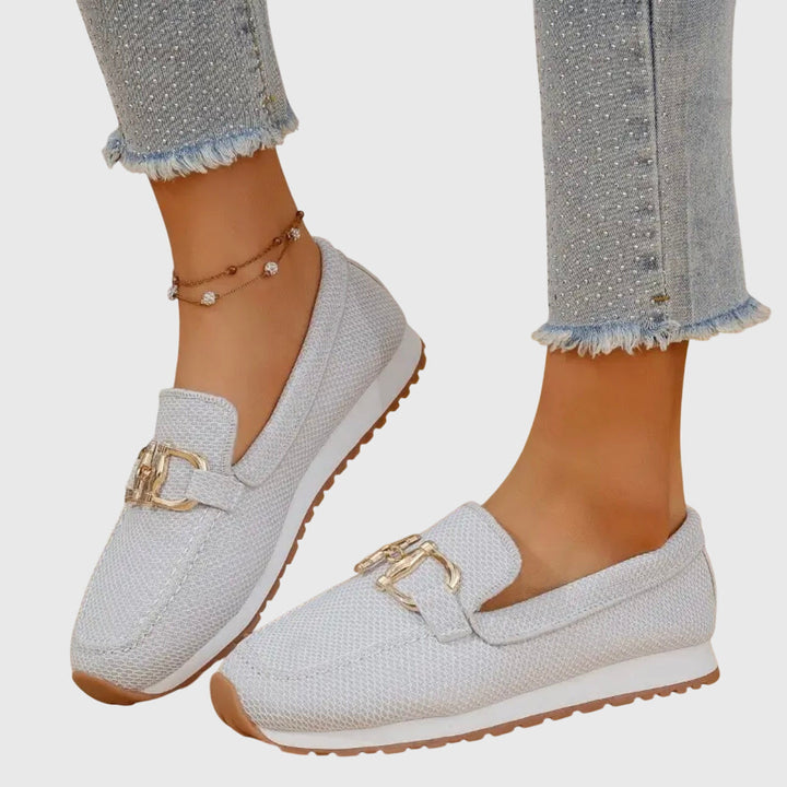 White chain-detail slip-on loafers with gold buckle hardware and textured weave