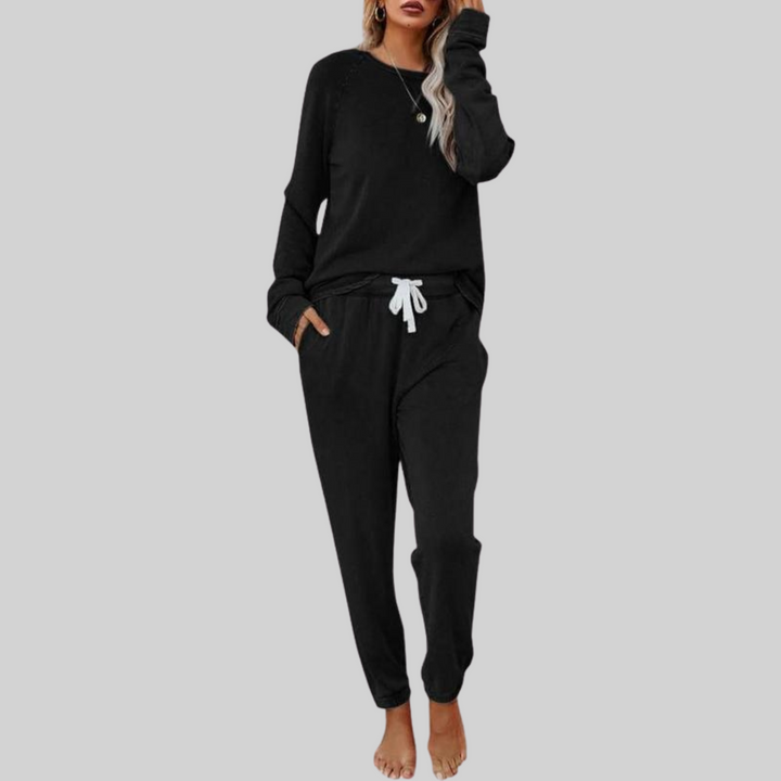 Black cozy lounge set: crewneck long-sleeve top and jogger pants with white drawstring.