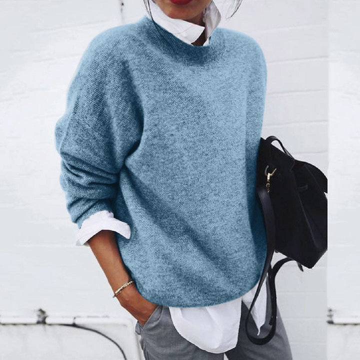Blue knit crewneck sweater with ribbed neckline and long sleeves.