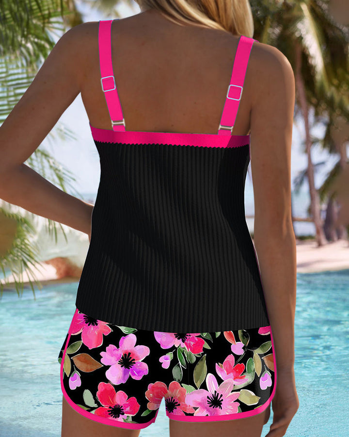 Black tankini set back view with fuchsia trim straps and floral shorts