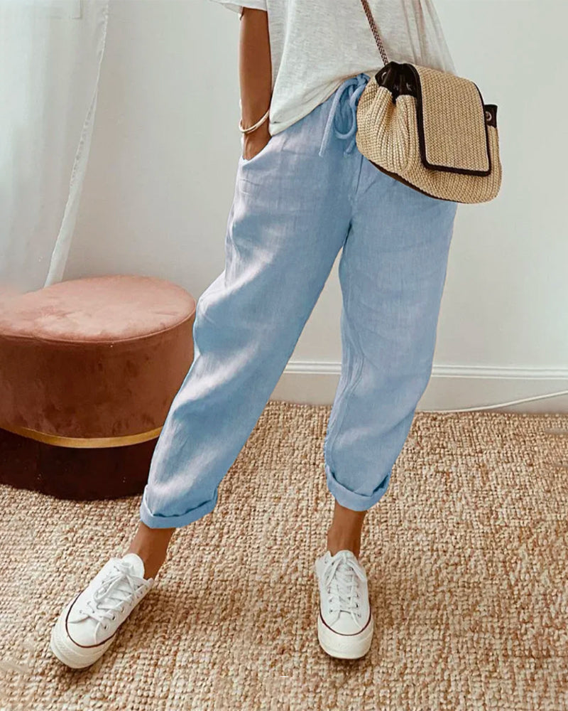 Blue relaxed drawstring pants with cuffed hem and adjustable waist tie.