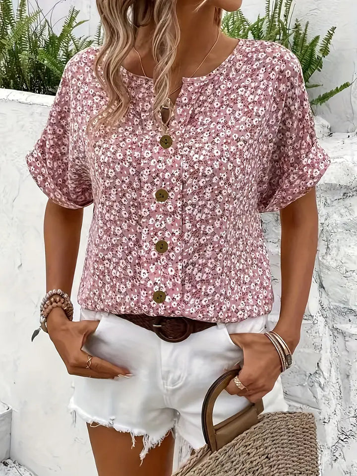 Pink floral button blouse with three-button front and short puff sleeves