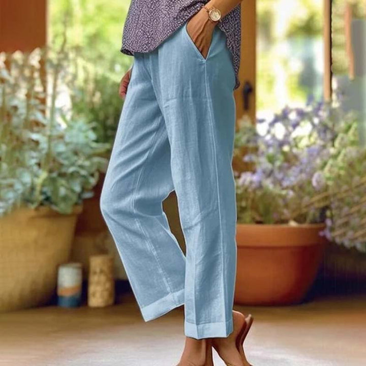 Relaxed summer pants, light blue wide-leg trousers with side vents and ankle cuffs.