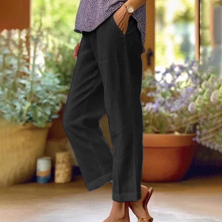 Relaxed summer pants, black wide-leg trousers with side vents and ankle cuffs.