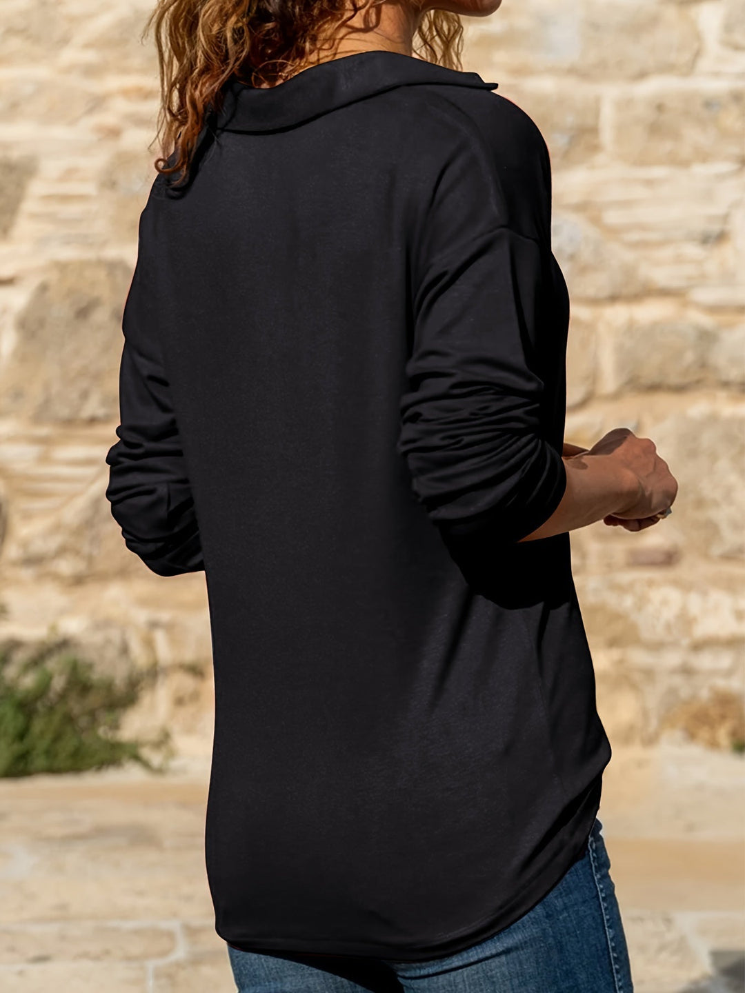 Black zip-collar long-sleeve top, back/side view
