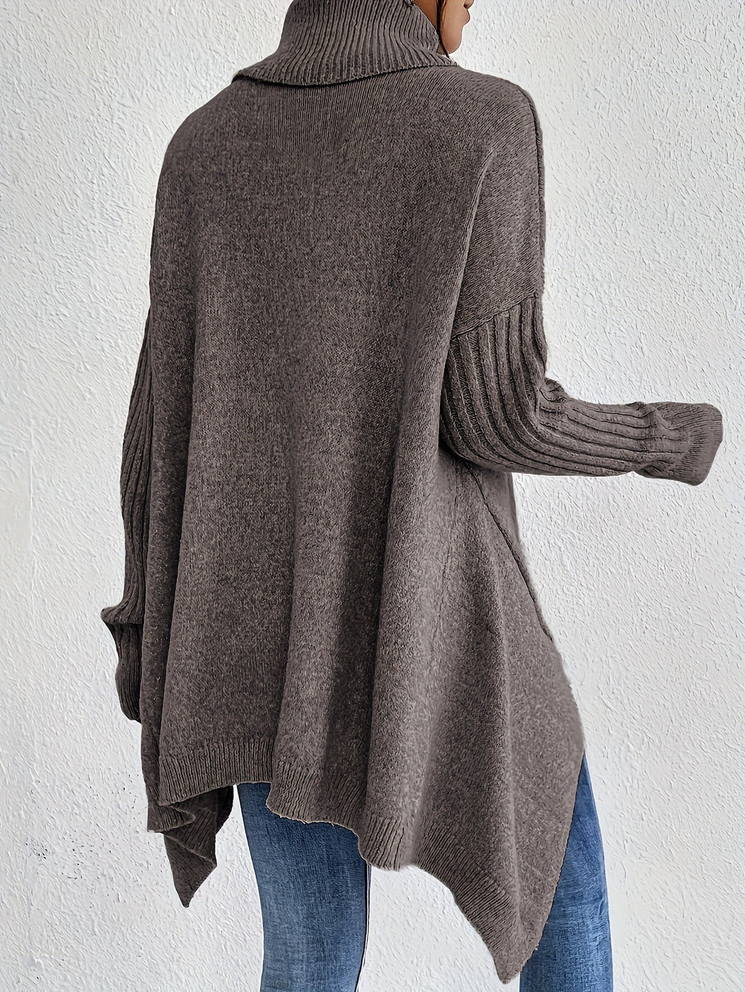 Back view of dark gray oversized turtleneck sweater, ribbed cuffs and long sleeves.
