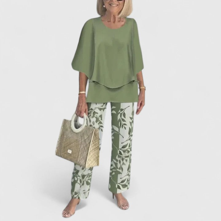 Two-piece blouse and trouser set with olive green blouse and leaf-print trousers
