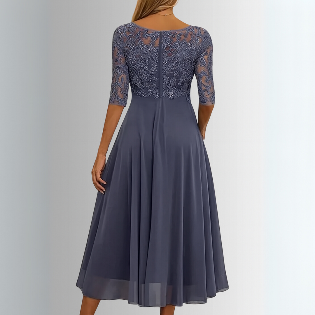 Navy lace evening dress, back view, embroidered lace sleeves and pleated skirt