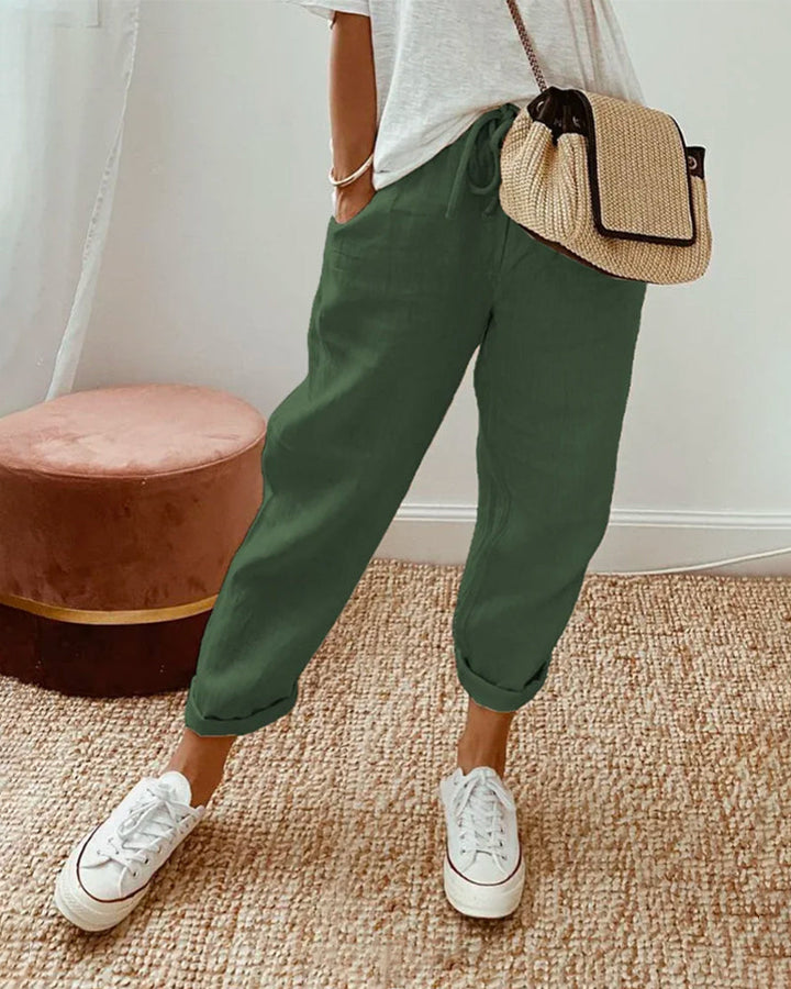 Green relaxed drawstring pants with cuffed hem and adjustable waist tie.