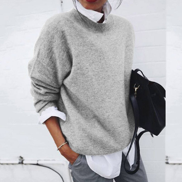 Gray knit crewneck sweater with ribbed neckline and long sleeves.