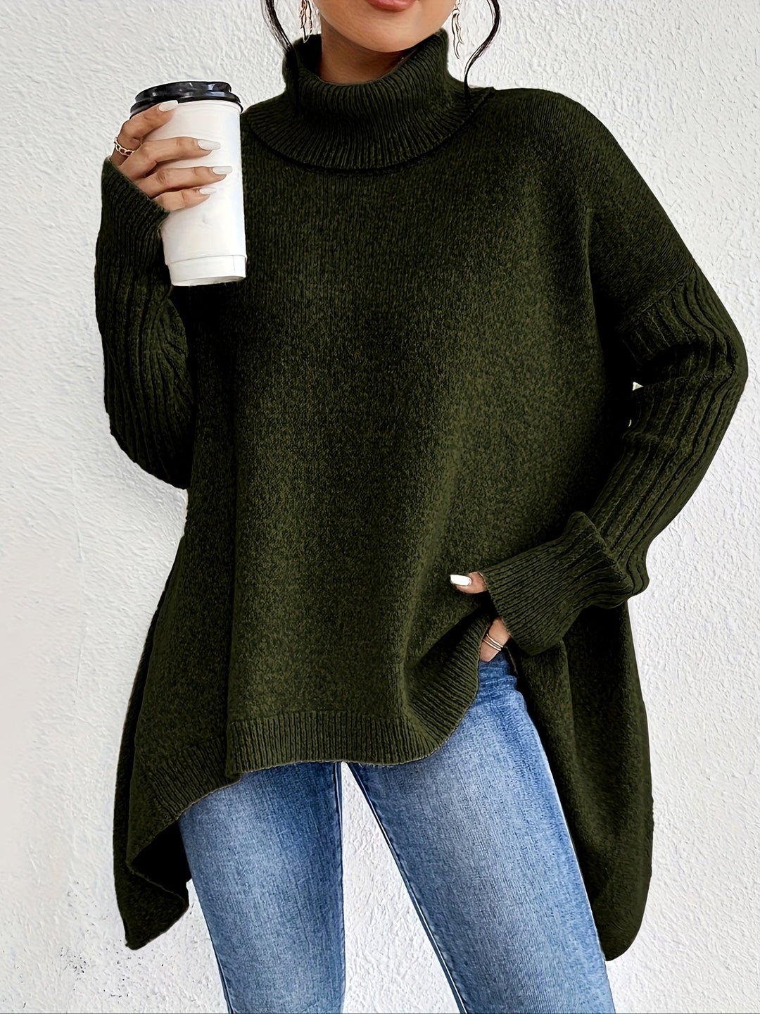 Olive green oversized turtleneck sweater with ribbed turtleneck, cuffs, and curved high-low hem