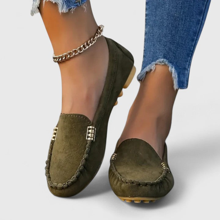Olive green suede slip-on loafers with metal buckle detail and stitched moc toe