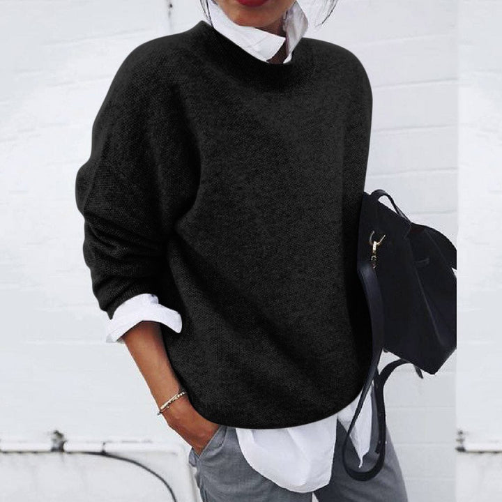 Black knit crewneck sweater with ribbed neckline and long sleeves.