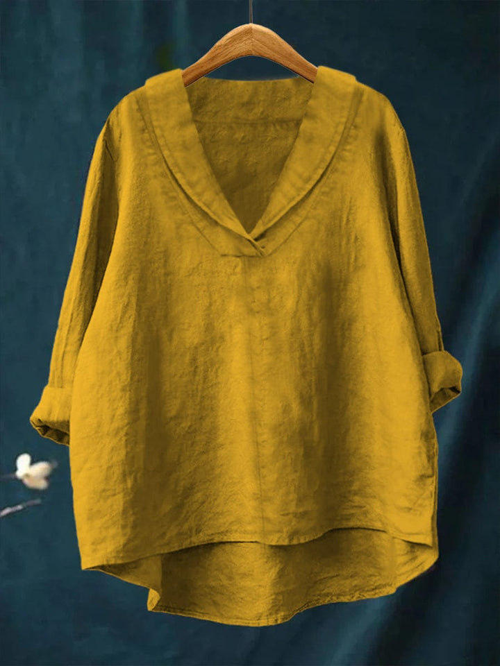 Yellow relaxed linen blouse with V-neck and loose fit, long sleeves, draped hem.