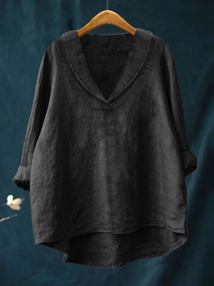 Black relaxed linen blouse with V-neck and loose fit, long sleeves, draped hem.
