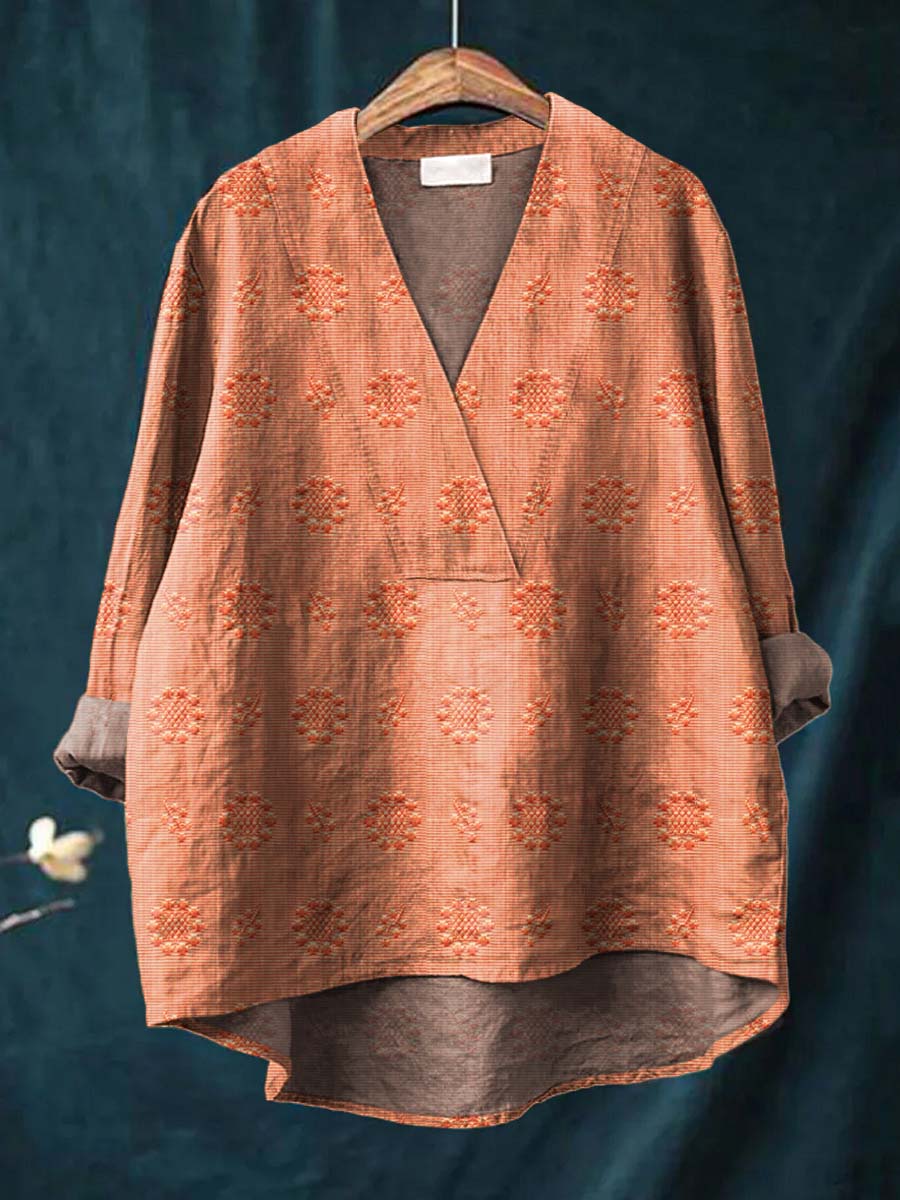Orange linen blouse with V-neck and all-over floral embroidery, relaxed drape