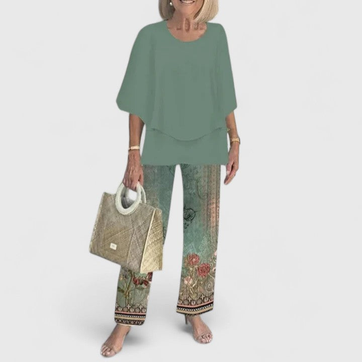 Two-piece blouse and trouser set with green blouse and botanical border print trousers