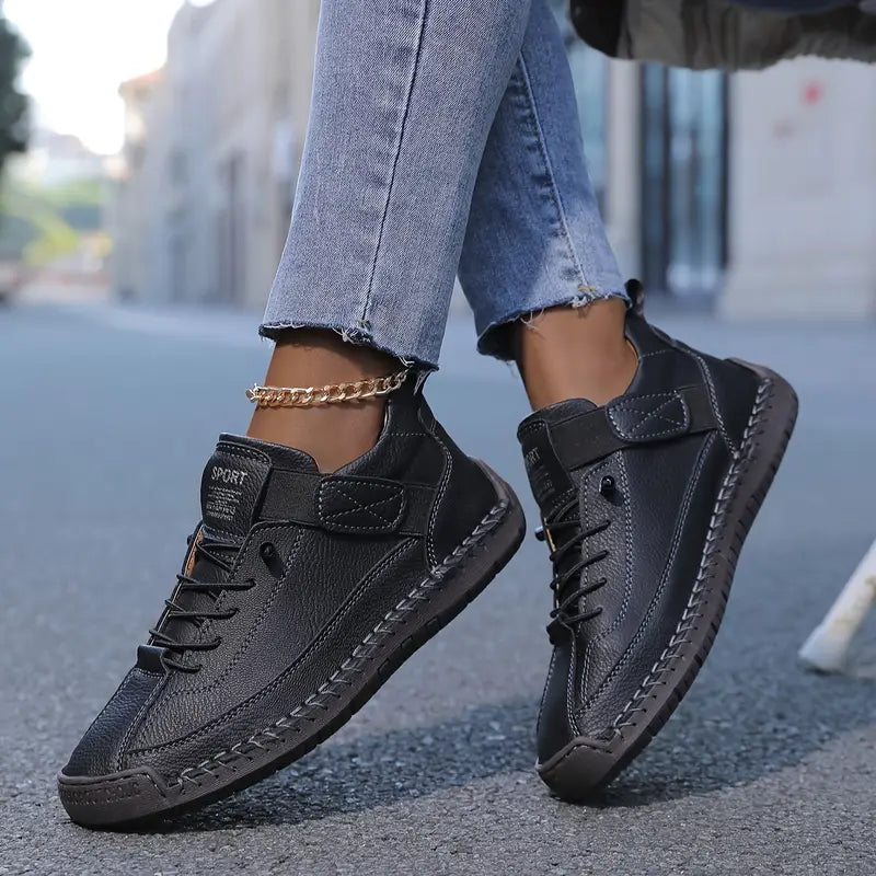 Black women's slip-on arch support trainer with strap and lace-up front