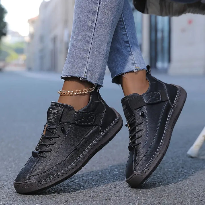 Black women's slip-on arch support trainer with strap and lace-up front