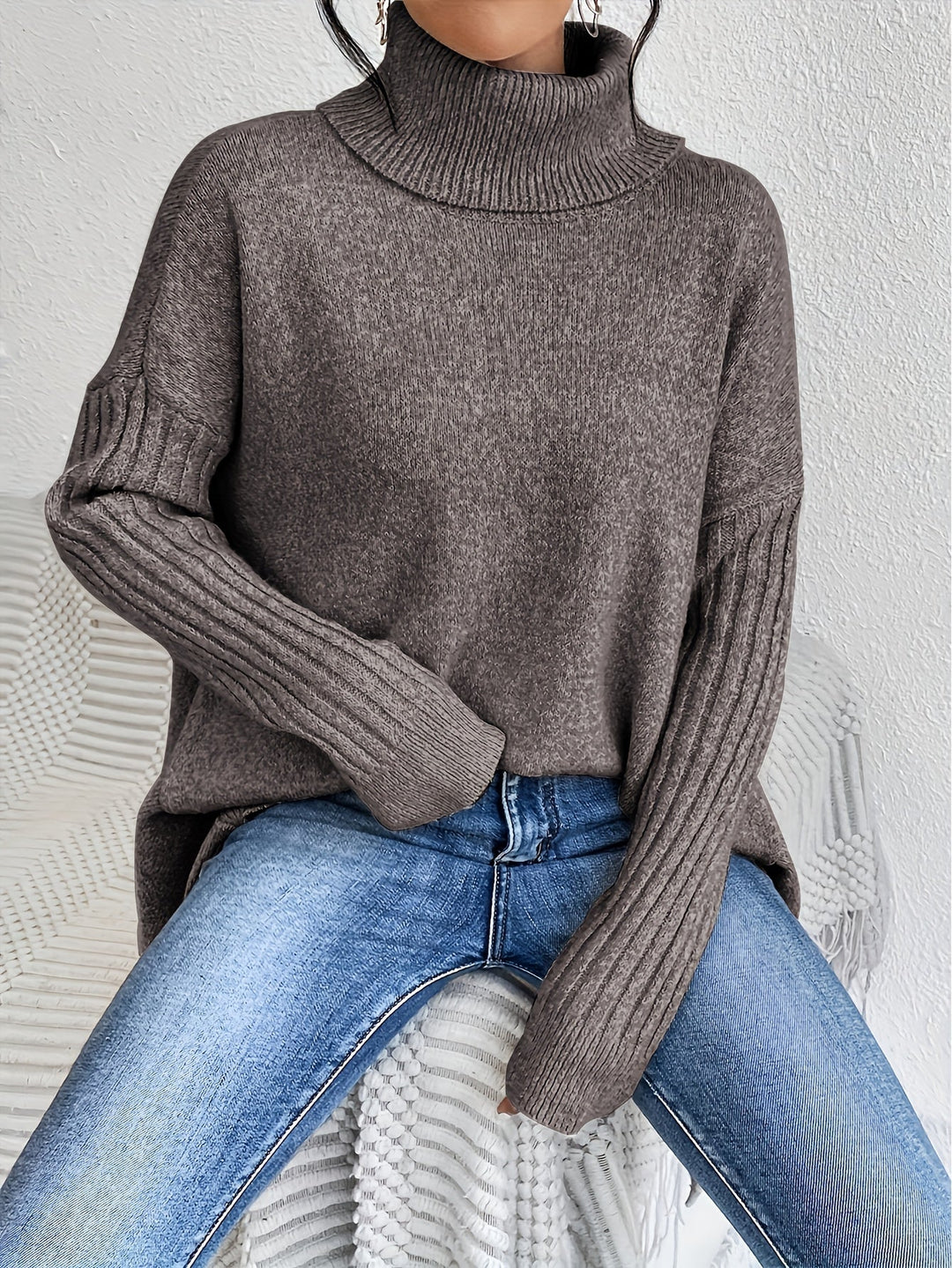 Dark gray oversized turtleneck sweater with ribbed cuffs, long sleeves, relaxed body.