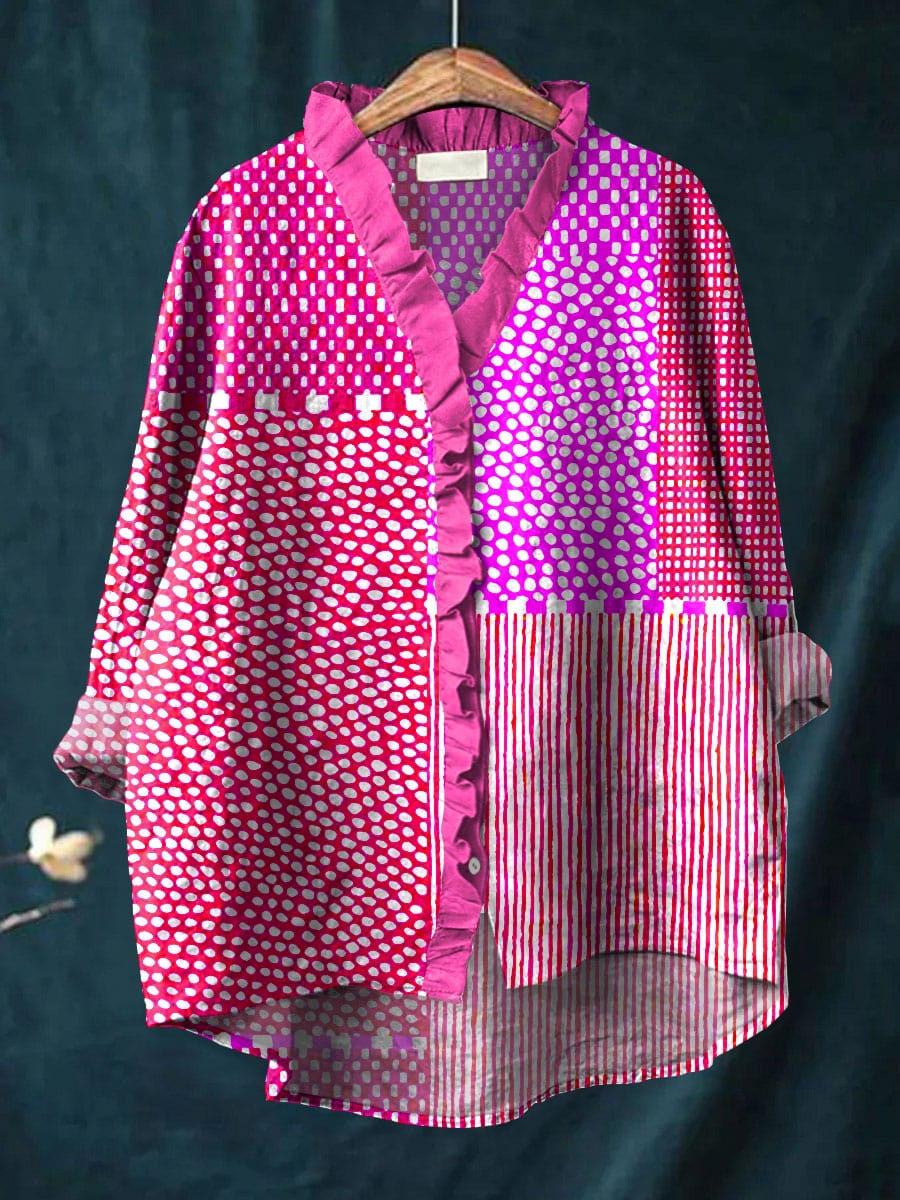 Relaxed blouse with ruffled V-neck, long sleeves, and pink patterned panels.