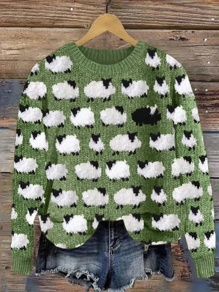 Green knit sweater with white sheep graphic pattern, ribbed crew neck and cuffs