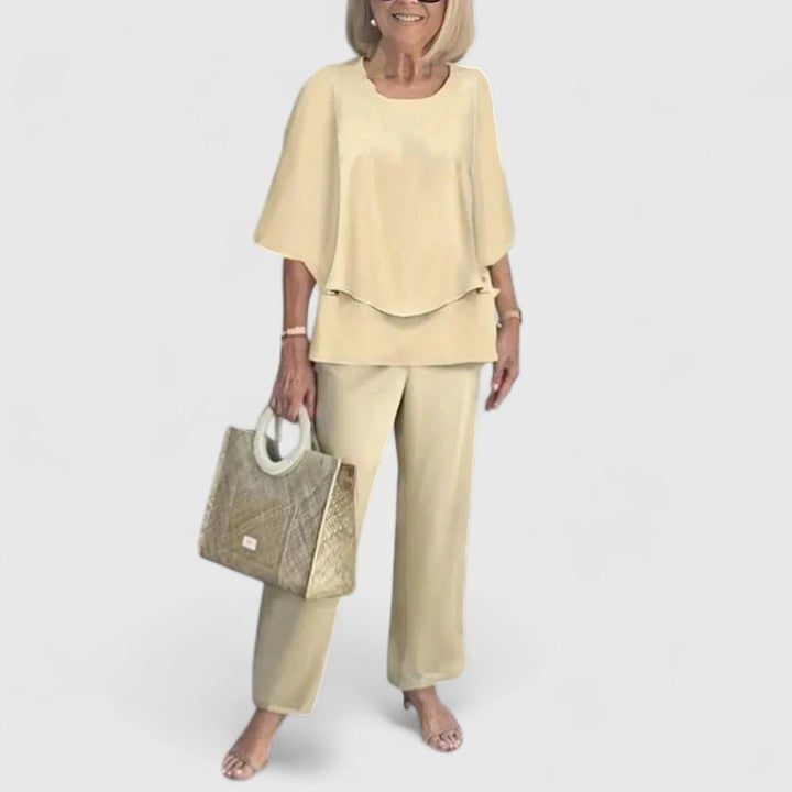 Two-piece blouse and trouser set with pale yellow blouse and matching solid trousers