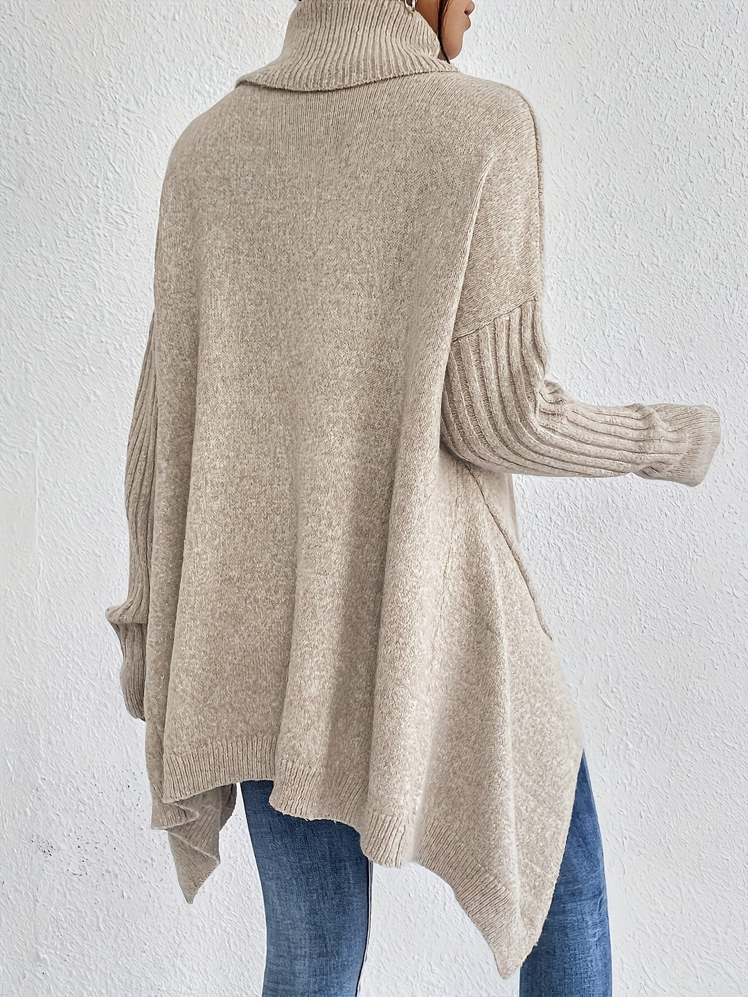 Oversized turtleneck sweater in light knit from back view, ribbed cuffs
