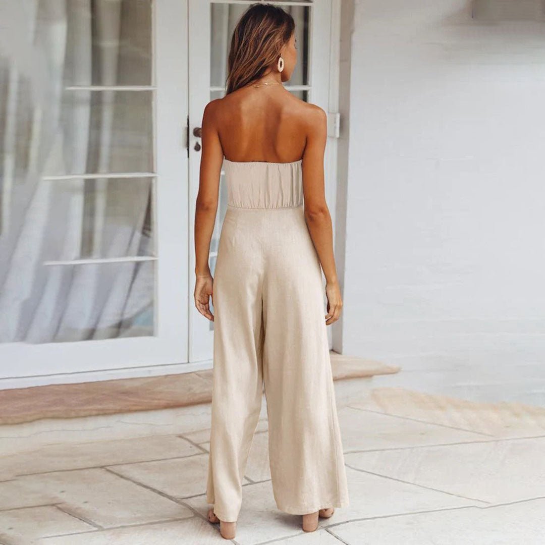 Back view of beige strapless tie-waist jumpsuit with wide-leg silhouette