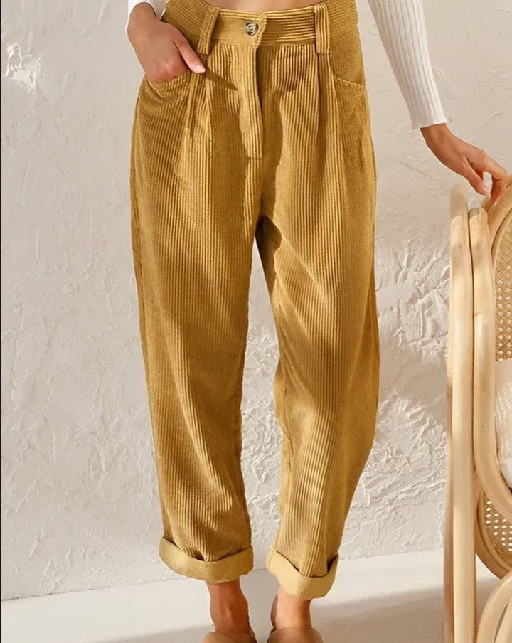 Relaxed corduroy pants in mustard with button front, side pockets, and cuffed hems