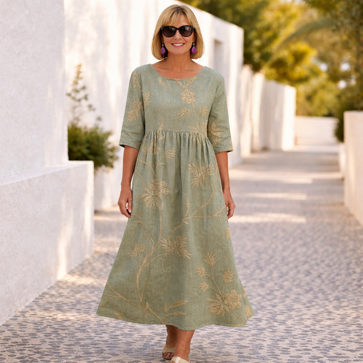 Floral dress in dusty green with gold botanical embroidery, three-quarter sleeves