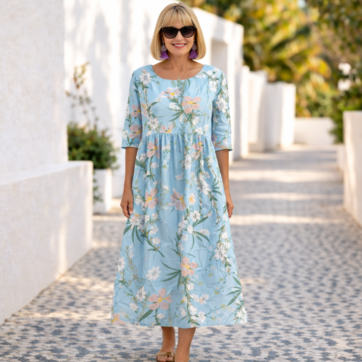 Blue summer floral dress with elbow-length sleeves and gathered skirt