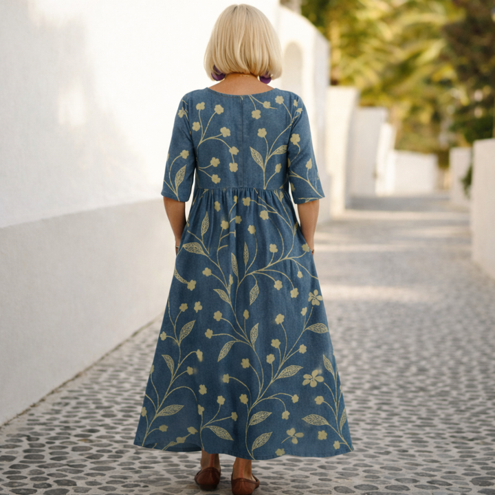 Navy midi dress with gold botanical print, three-quarter sleeves, back pleated waist