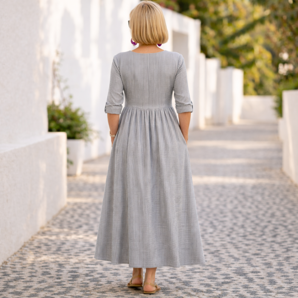 Gray striped midi dress from back with gathered waist and 3/4 sleeves