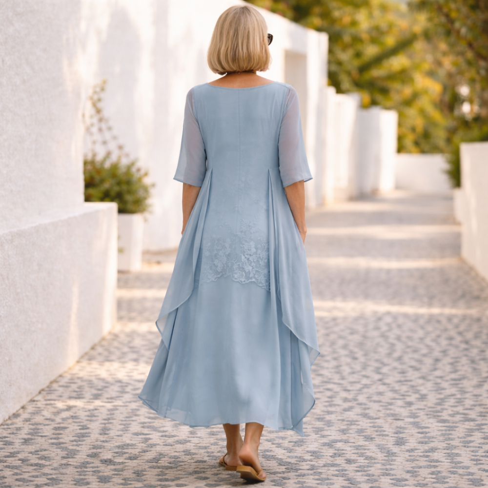 Sky blue back view of long elegant dress with lace hem detail and draped overlay