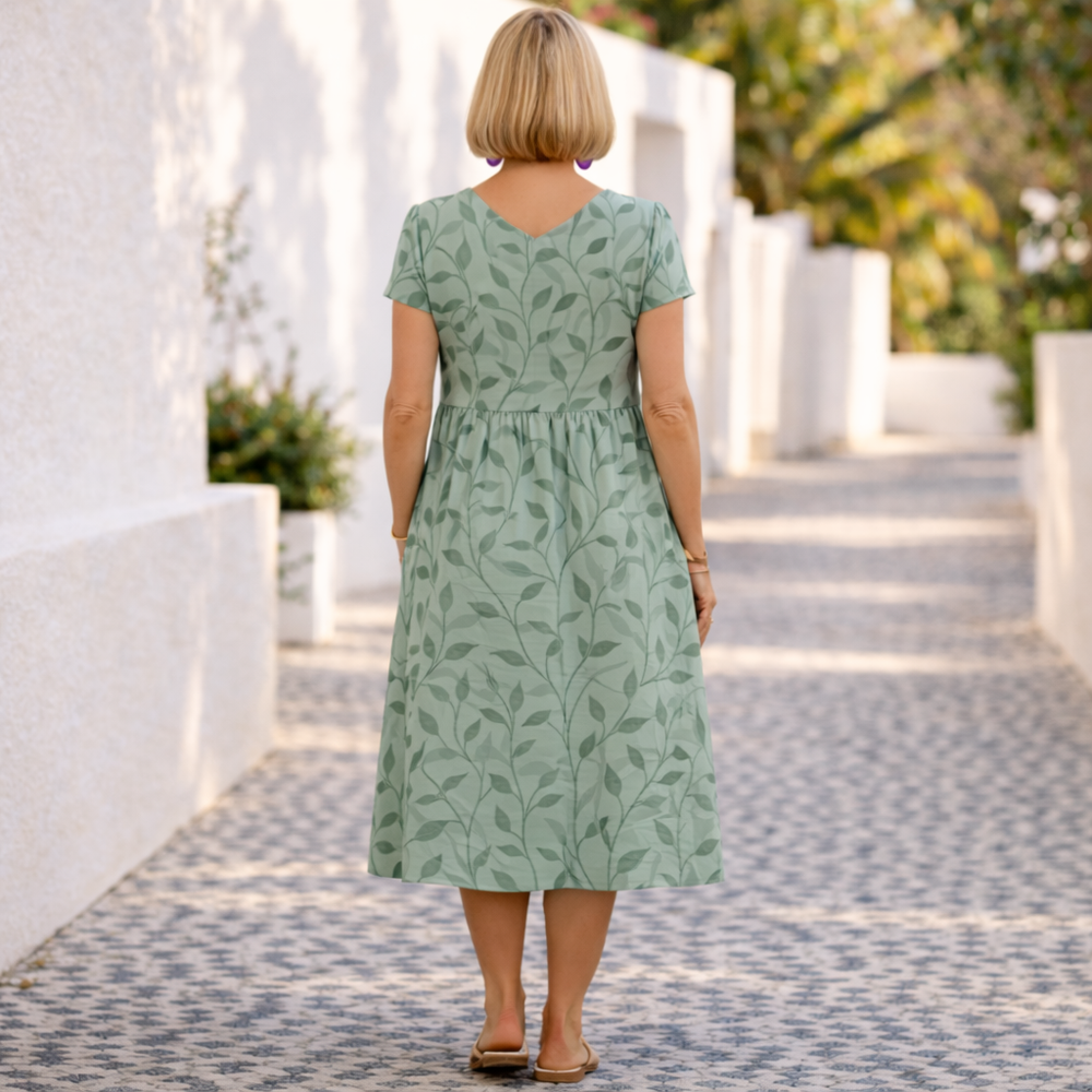 Calisse elegant summer dress in green leaf print, back view with gathered skirt