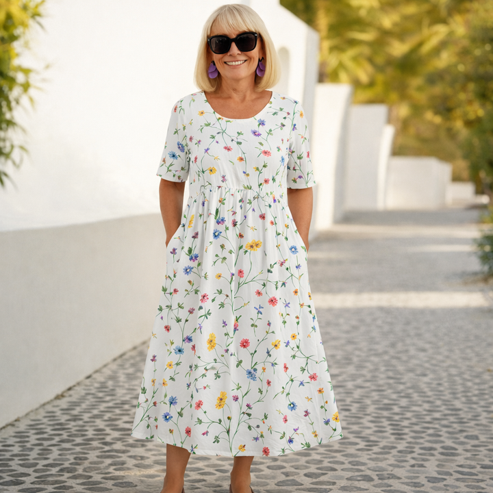White floral midi dress with short sleeves and gathered skirt
