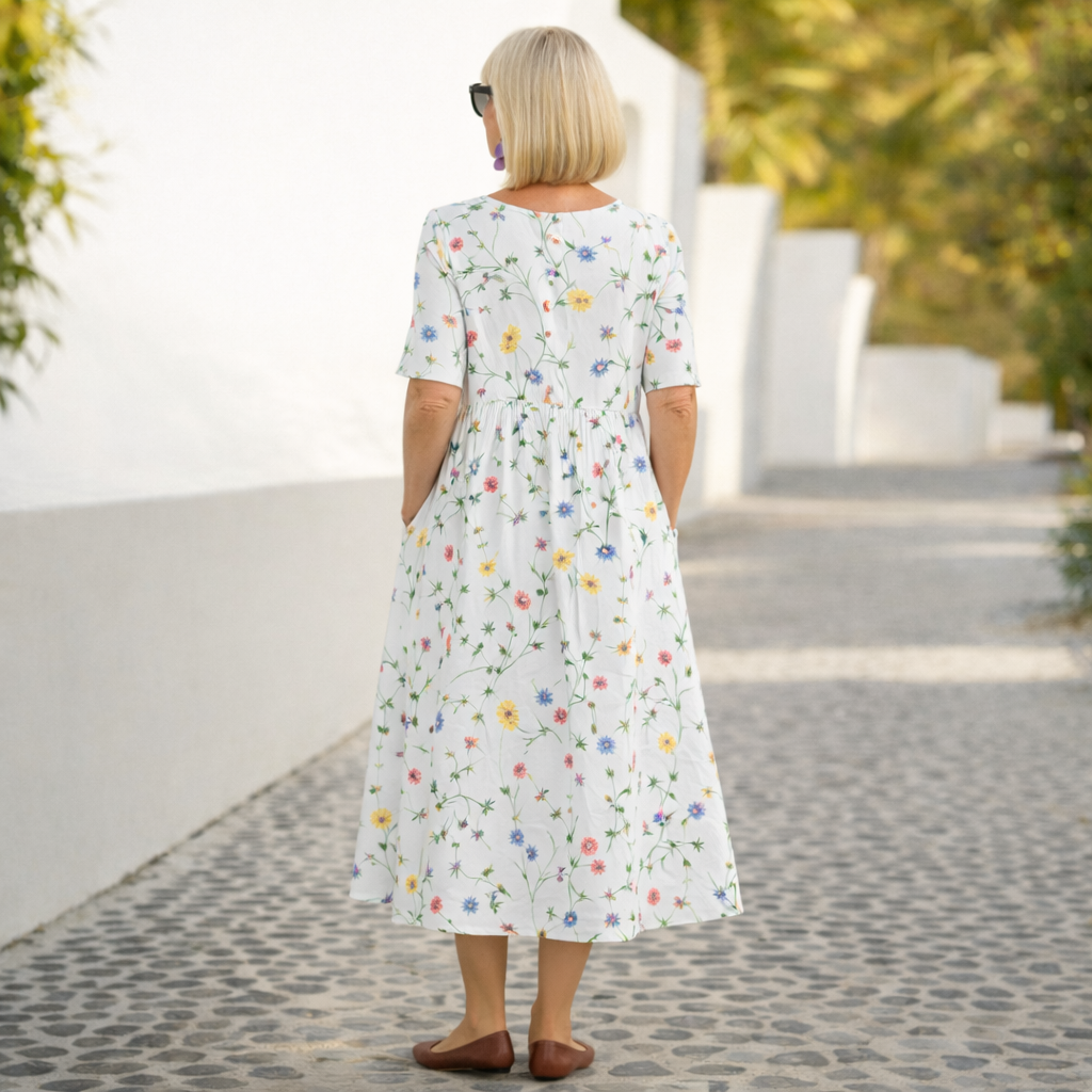 White floral midi dress with short sleeves and gathered back